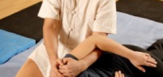 Man Stretching Shoulder of Woman during Thai Massage